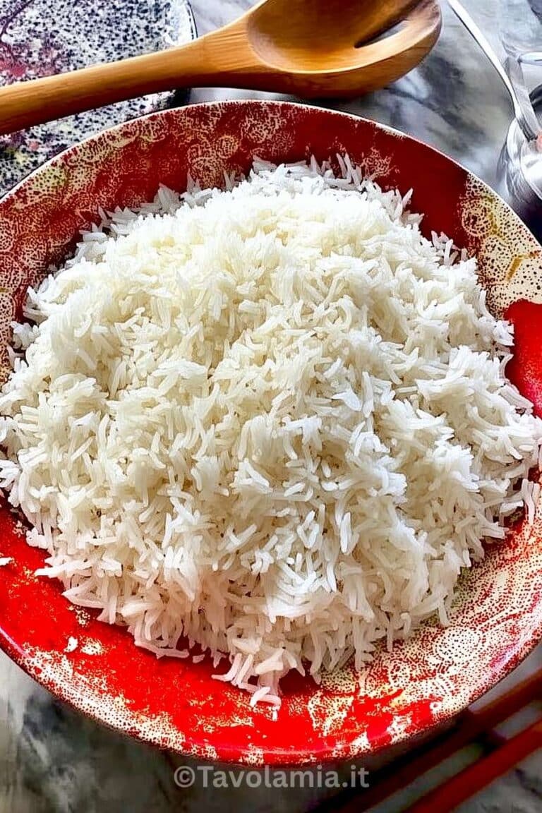 Riso basmati cotto, servito soffice in ciotola rossa decorativa